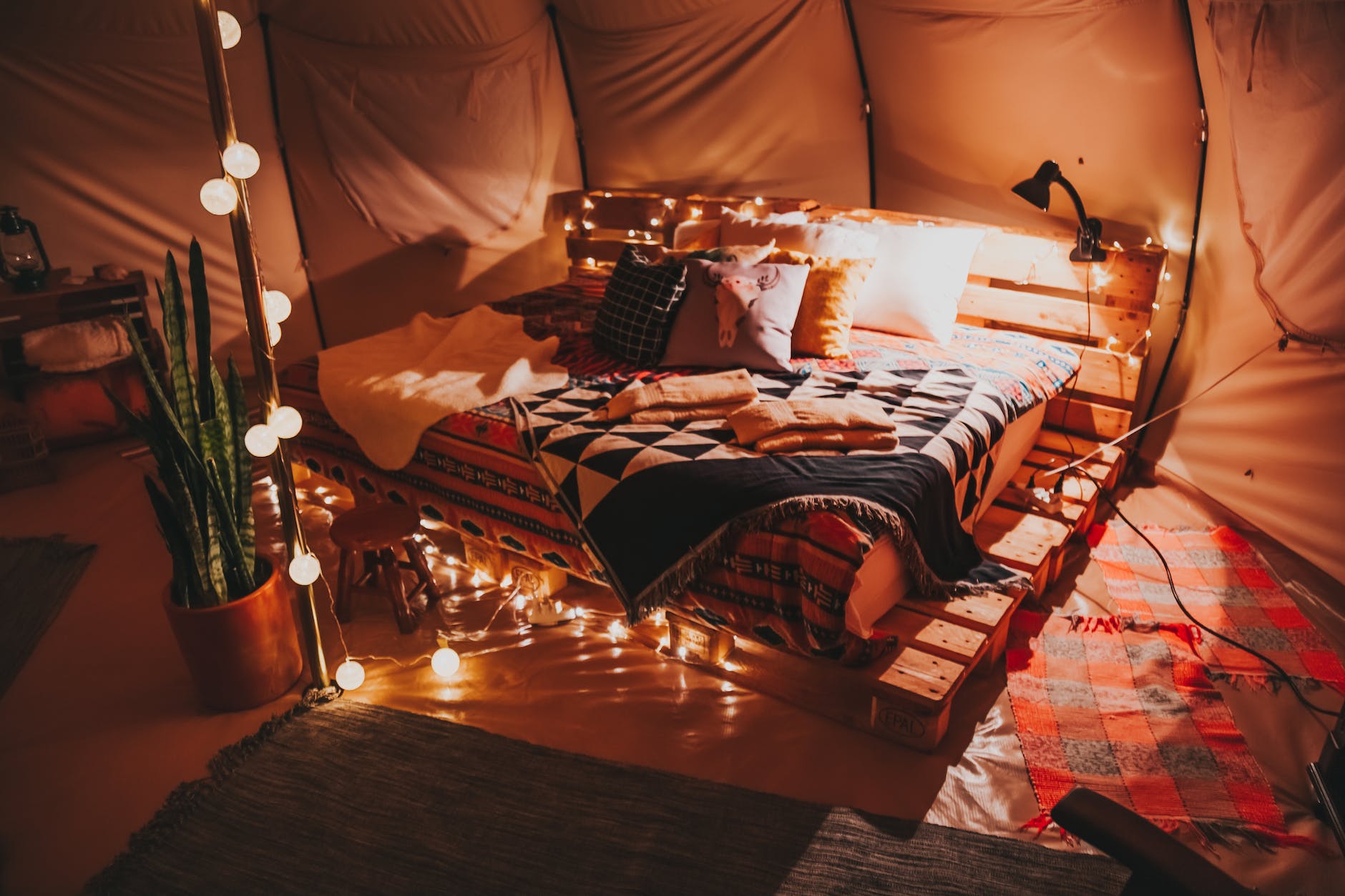 bed made of pallets inside tent